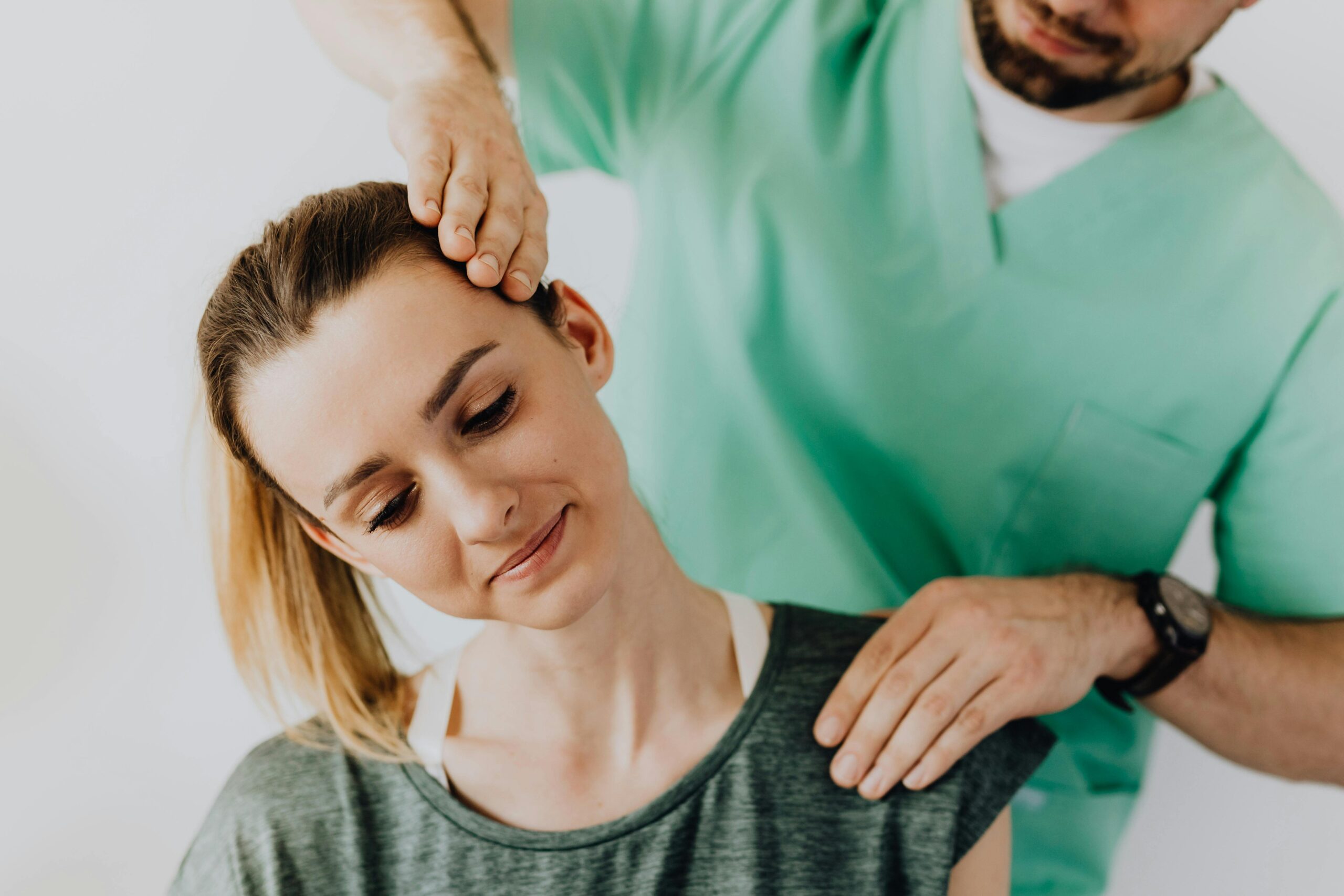 Home Chiropractor treating a female patient for neck pain and posture alignment.